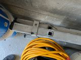 a person standing next to a yellow hose on the floor
