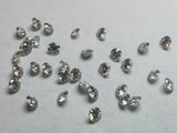 diamonds are scattered on a white surface with a white background
