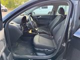 the interior of a car with the door open and the driver ' s seat up