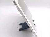 a tablet computer sitting on a stand on a white surface