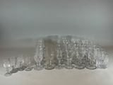 a lot of glasses and cups sitting on a table