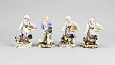 three figurines of people with hats and aprons on a gray surface
