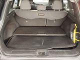 a trunk of a car with luggage in the back