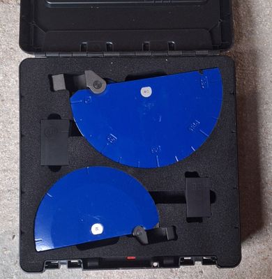 two blue discs in a black case on the floor