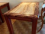 a wooden table and chairs in a room with tile flooring