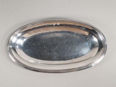 a silver tray with a silver handle on a table
