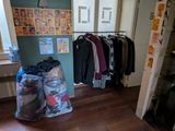 a room with a bunch of clothes hanging on the wall