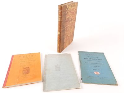 three books are sitting next to each other on a white surface