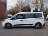 the white van is parked in the parking lot near other cars