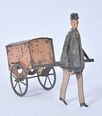 une figurine représentant un homme avec une charrette sur fond blanc
