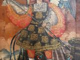 an old painting of a man with a sword and wings on a wall