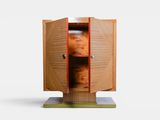 a wooden cabinet with two doors open on a white surface