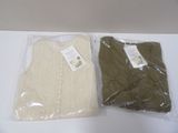 two sweaters that are sitting on a table