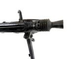 a small machine gun on a stand on a white background