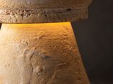 a close up view of a stone pedestal with a light on it