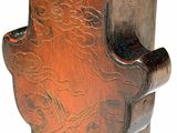 a wooden vase with a carved design on it