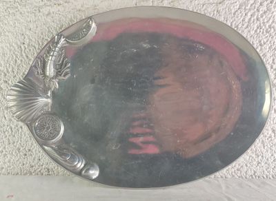 a silver plate with a woman ' s face in it
