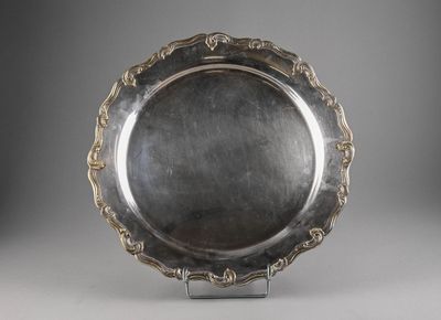 a silver plate with a decorative design on the rim