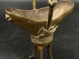an image of a bronze statue of a bird on a pedestal
