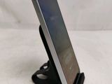 a close up of a cell phone on a stand on a white surface