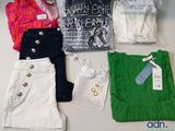 a lot of clothes that are sitting on a table