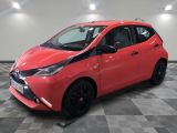 a red toyota ay parked on a checkered floor