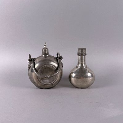 two silver vases with handles and handles on a white surface