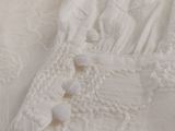 a close up of a white shirt with buttons on it