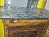 a marble counter top on a wooden cabinet in a room