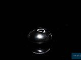 a black and white photo of a ball in the dark