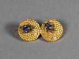 a pair of gold earrings with sapphires and diamonds