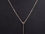 a silver necklace with a bar pendant on a mannequin mannequin mannequin mannequin mannequin mannequin mannequin manne