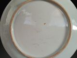 a white plate with a brown rim sitting on a table