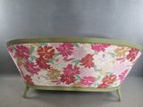an image of a pink and green couch with a floral pattern