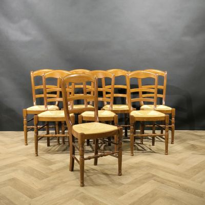 a set of six wooden chairs with rushing seats