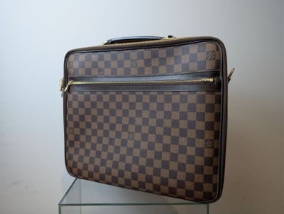 a brown and black suitcase sitting on top of a glass table