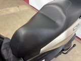 a black and silver motor scooter parked in a garage