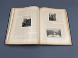 an open book on a table with pictures of a bridge and trees
