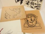 several different types of art work are displayed on a table