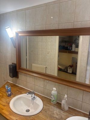 a bathroom with a sink and a mirror on the wall