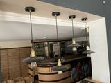 a picture of a kitchen with a bar and several lights