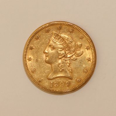 an image of a gold coin with a woman ' s head on it