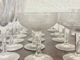a lot of wine glasses sitting on a wooden table
