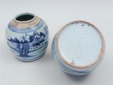 two blue and white vases sitting next to each other on a white surface