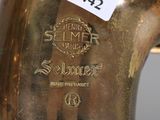 a gold saxophone that has a label on it