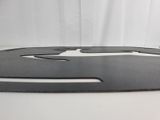 batman symbol cut out of metal on a white table