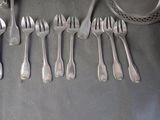 a lot of silver forks and spoons on the table