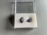 pair of amethtites in a clear box on a table