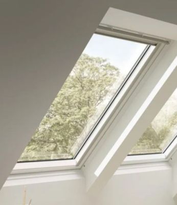 three windows in the roof of a room that have been painted white