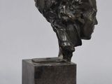 an image of a bronze statue of a man with a hat on his head